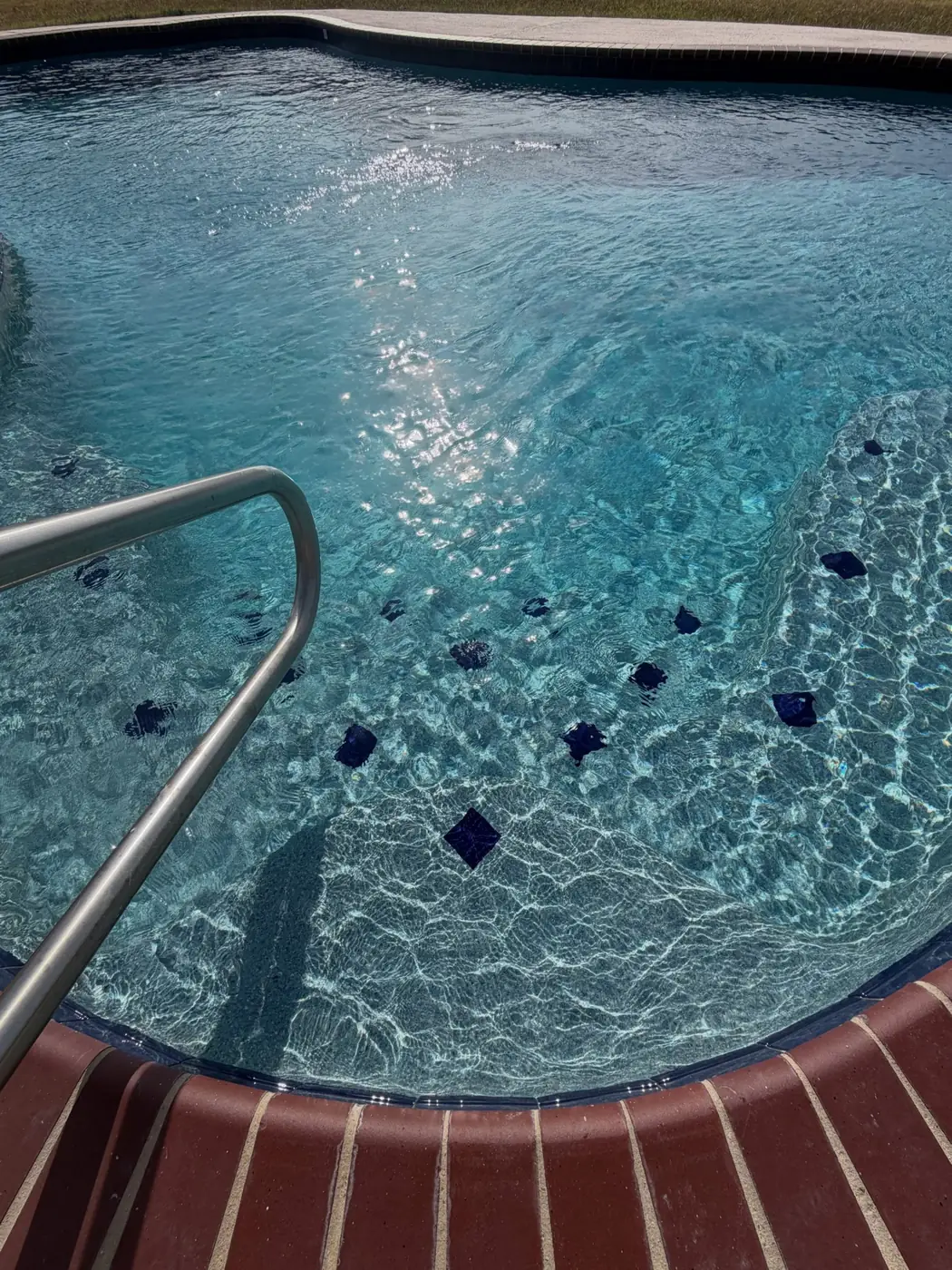 The same pool after Kingdom Pools cleaned it, with clear blue water
